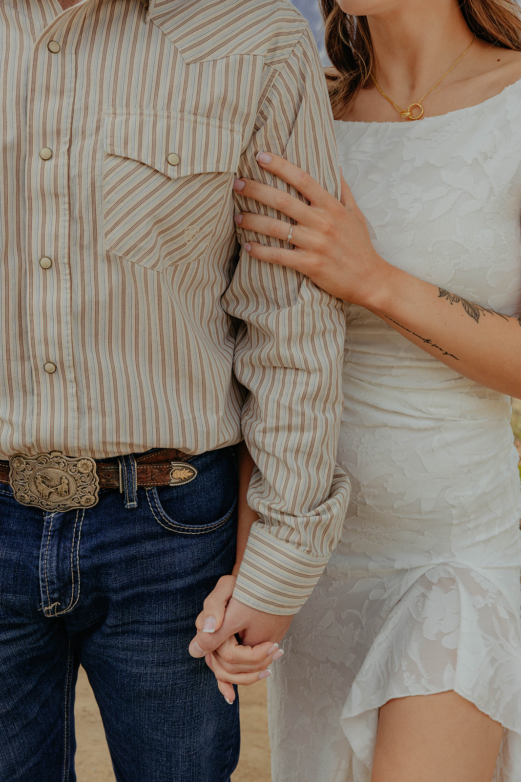 Madalyn holding Hunter's arm with her engagement ring visible