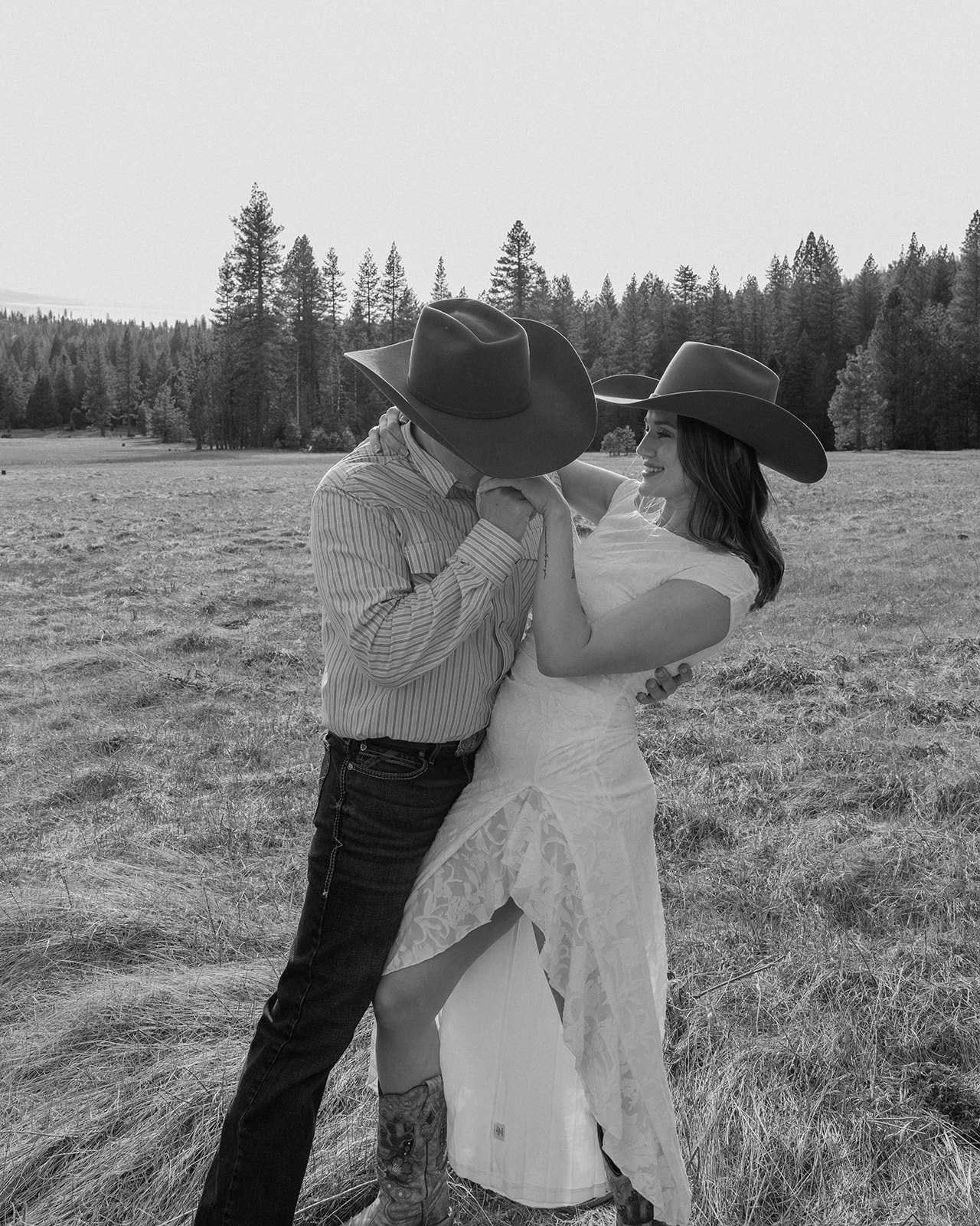 Hunter kissing Madalyn's hand during their engagement session